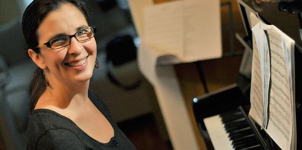 Woman playing piano during an adult piano lesson in Toronto