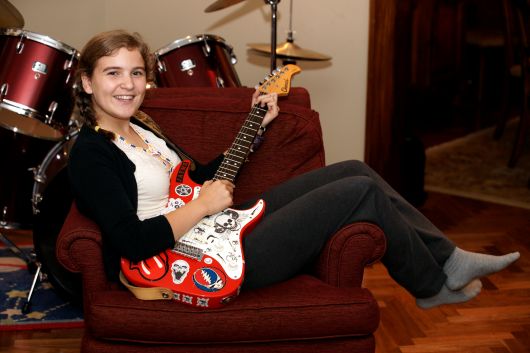Young student practicing piano on a grand piano during a music lesson