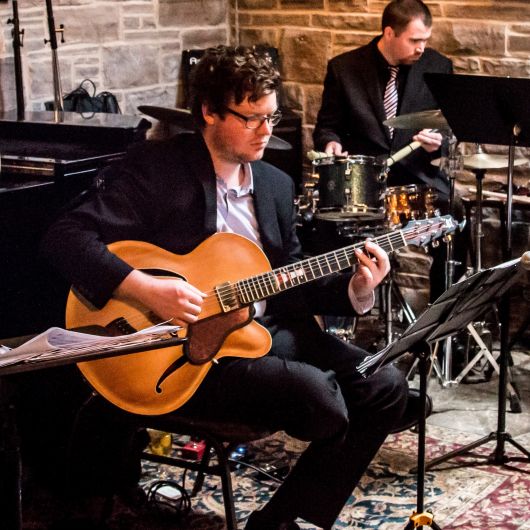 Young child playing piano during a beginner piano lesson in Toronto