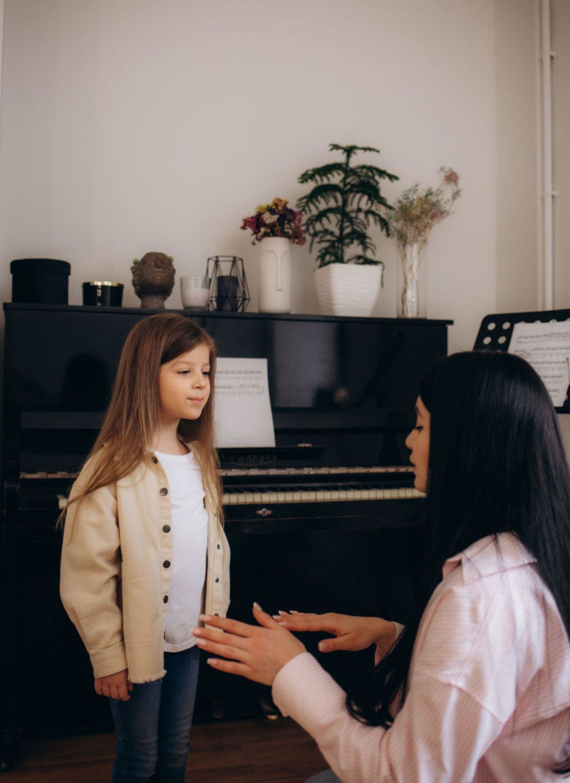 Child taking a singing lesson with a vocal teacher